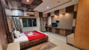 A modern bedroom with a bed, bedside table, and a red throw blanket.