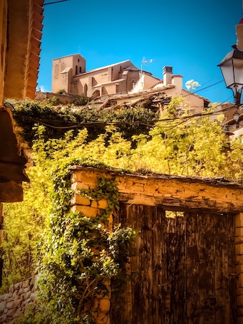 A historic building with a stone facade, a wooden door, and a view of a clear blue sky.. Country House 'Zulotxo' with Mountain View, Private Terrace and Wi-Fi