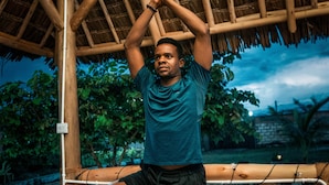 A person performing a yoga pose on a mat under a bamboo structure. - Cozy A-Frame Retreat in Zanzibar Nungwi Leo Glamping (Nungwi)