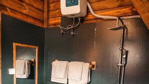 A bathroom with a wooden ceiling, a white sink, a mirror, and a shower. - Cozy A-Frame Retreat in Zanzibar Nungwi Leo Glamping (Nungwi)