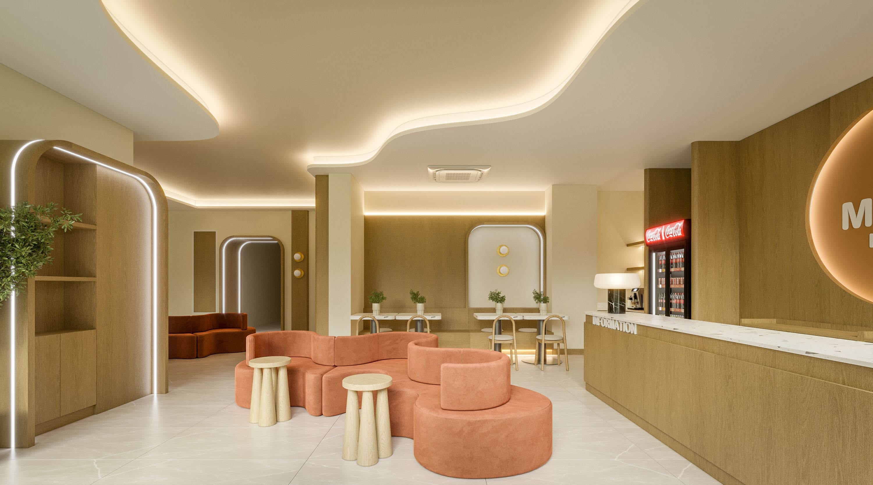 A modern lobby with a reception desk, seating area, and a Coca-Cola refrigerator.
