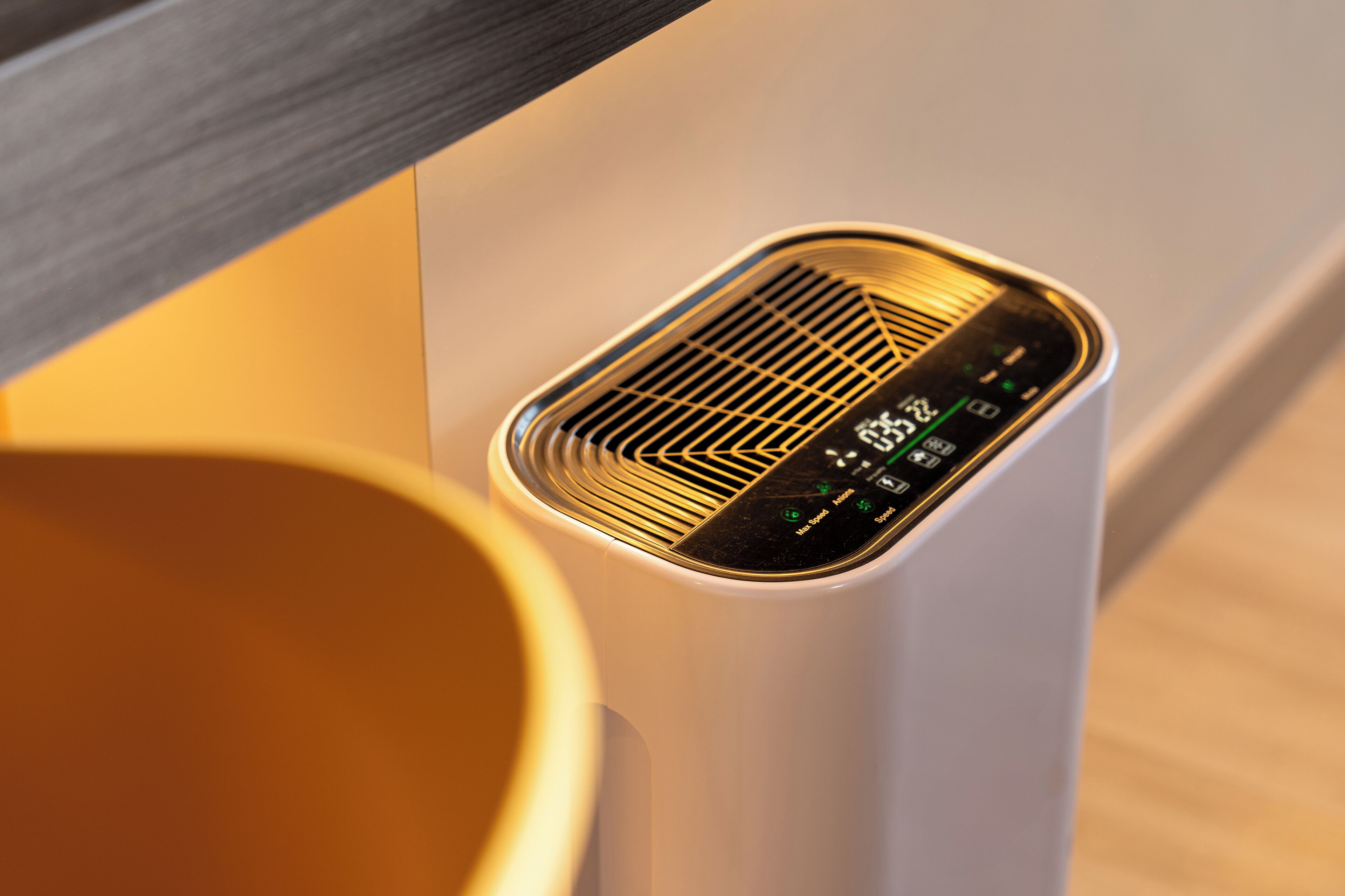 A white, modern air purifier with a digital display and ventilation grille.