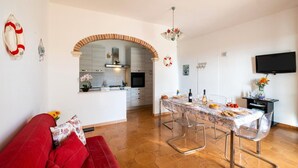 A modern kitchen with an archway leading to a dining area.