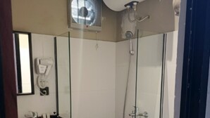A modern bathroom with a glass-enclosed shower, a vanity with a sink, and a toilet. - Nusantara Cabin and Coffee (Sepaku)