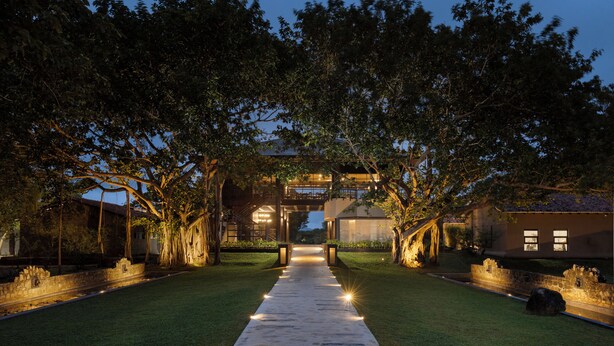 A pathway leading to a building with a covered walkway and trees on either side. - Ayugiri Ayurveda Wellness Resort  (Sigiriya)