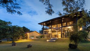 A modern two-story building with a covered outdoor area and a staircase leading to the upper level. - Ayugiri Ayurveda Wellness Resort  (Sigiriya)