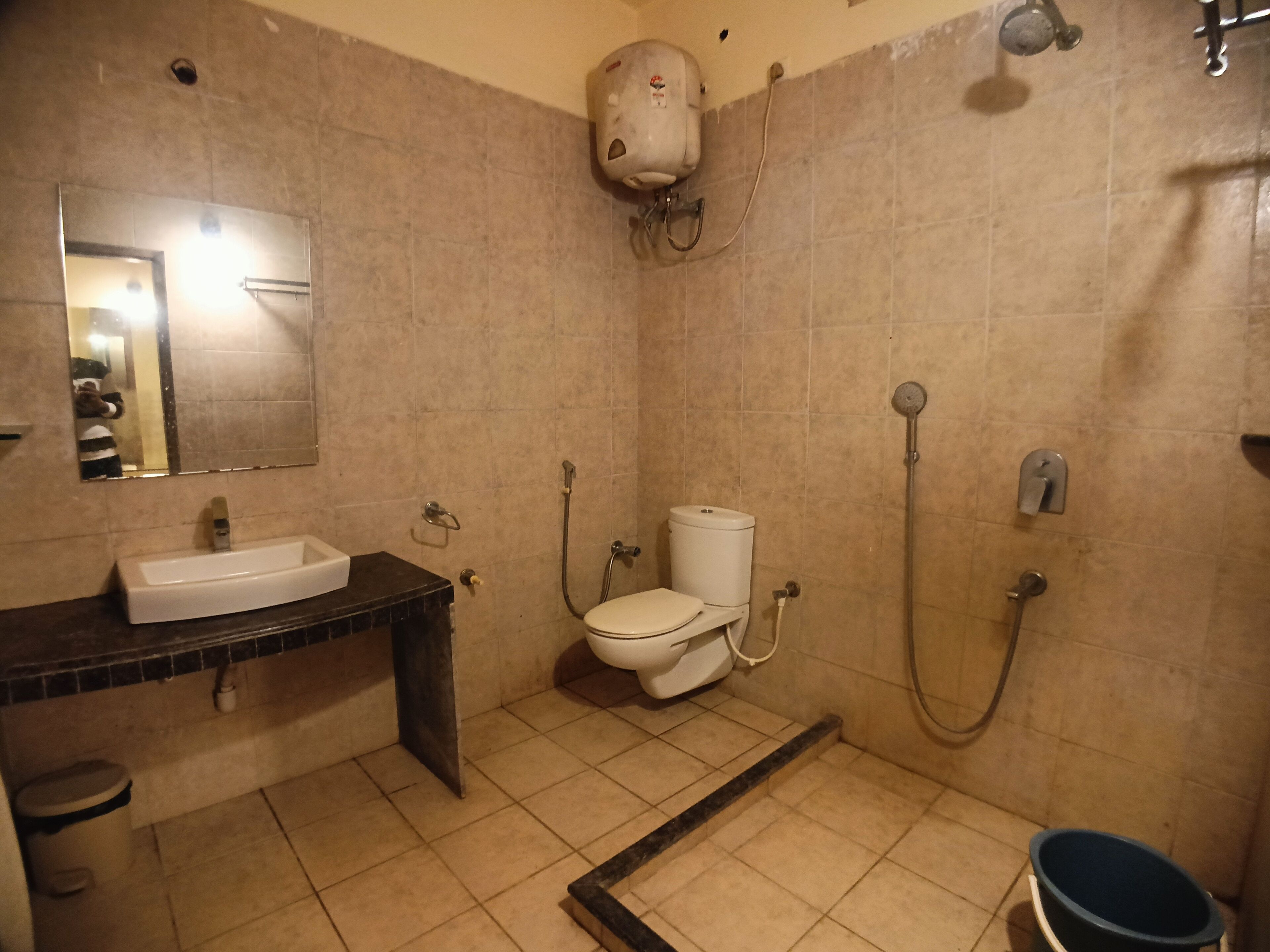 A bathroom with a sink, toilet, and shower.