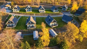 An aerial view of a residential area with houses arranged in a semi-circular pattern around a central road.