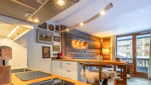 A modern kitchen with a wooden countertop, built-in appliances, and a rustic decor.