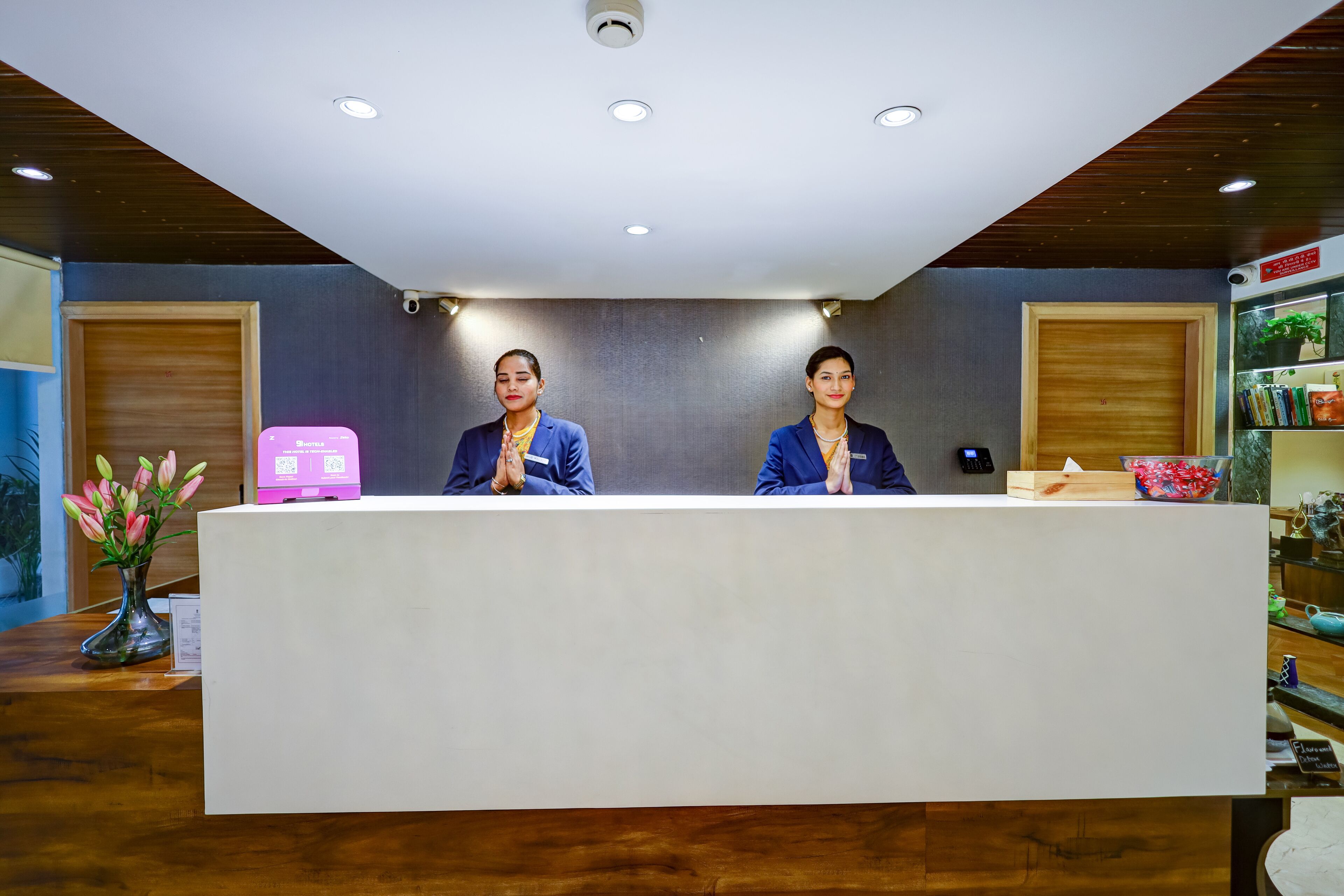 A reception desk with two staff members.