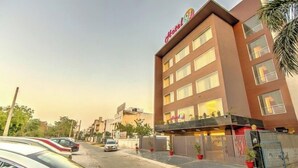 A hotel with a modern facade, multiple windows, and a visible entrance. - Hotel 91 Huda Premier (Gurugram)