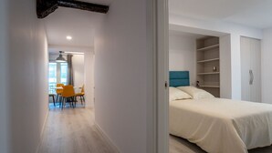 A bedroom with a bed, a wardrobe, and a dining area with chairs. - Two bedroom  in Spain, Santander (Santander)