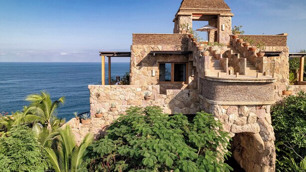 A stone building with a view of the ocean.