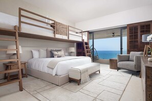 A modern bedroom with a bunk bed, a desk, a chair, and a view of the ocean. - Casa Ravello: Luxury Villa, Full Service & Premier Golf (Punta Mita)