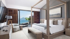 A modern bedroom with a four-poster bed, a desk with a lamp, a bench, and a view of the ocean. - Casa Ravello: Luxury Villa, Full Service & Premier Golf (Punta Mita)