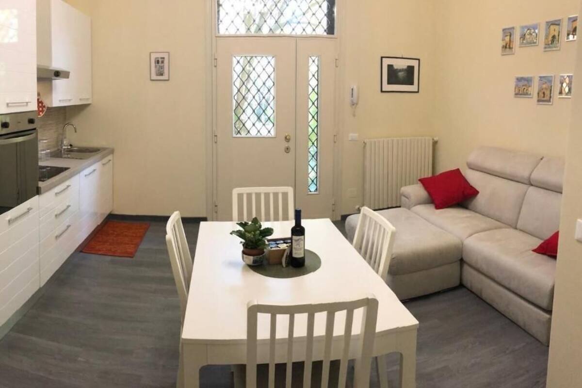 A compact living space with a kitchenette, dining area, and seating area.