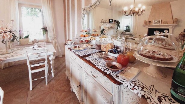 Un comedor con una mesa de buffet, una araña y una chimenea.