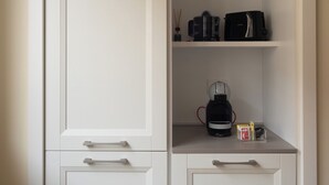 A white wardrobe with two drawers and a shelf.