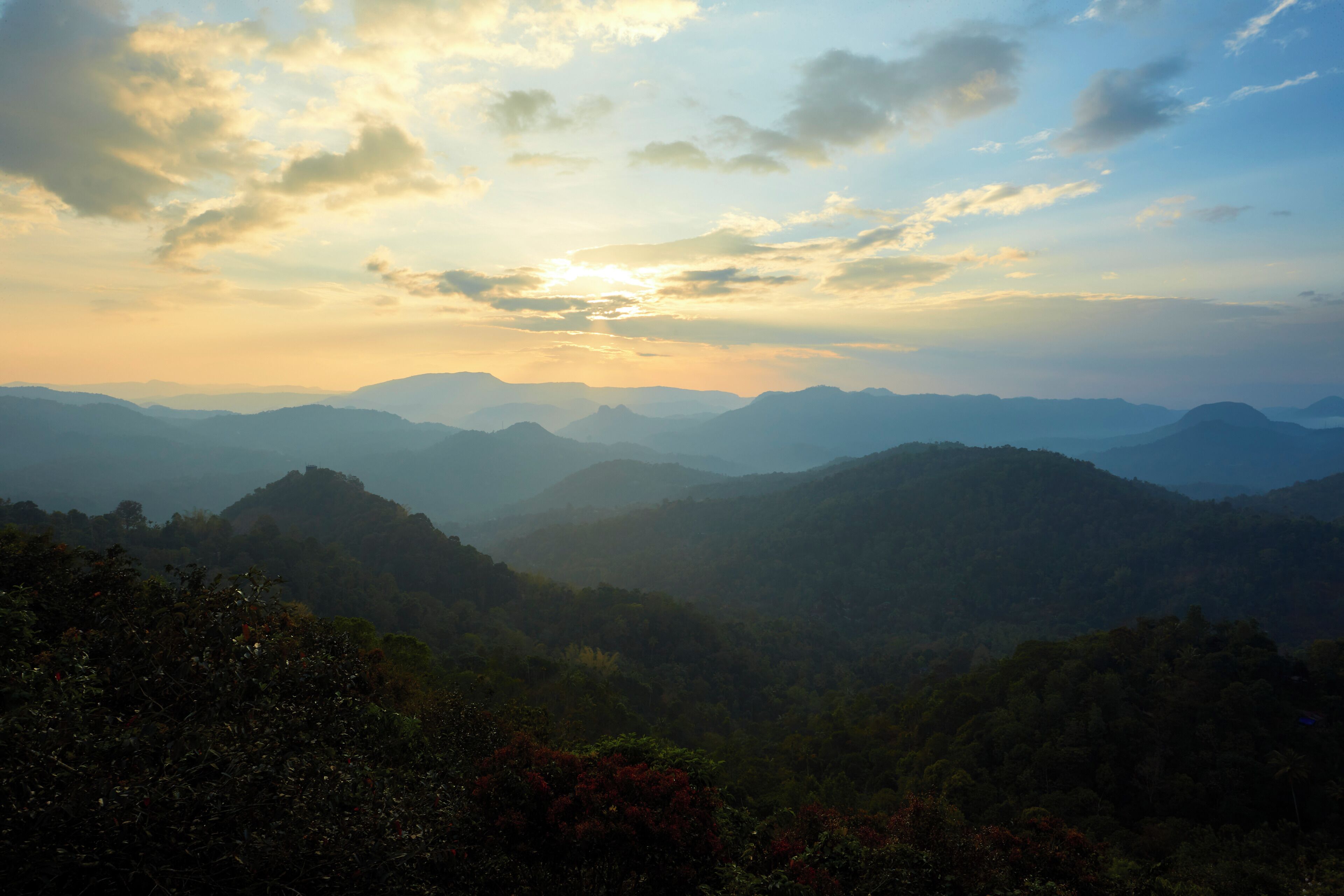 A mountainous landscape with a view of distant hills and a clear sky.