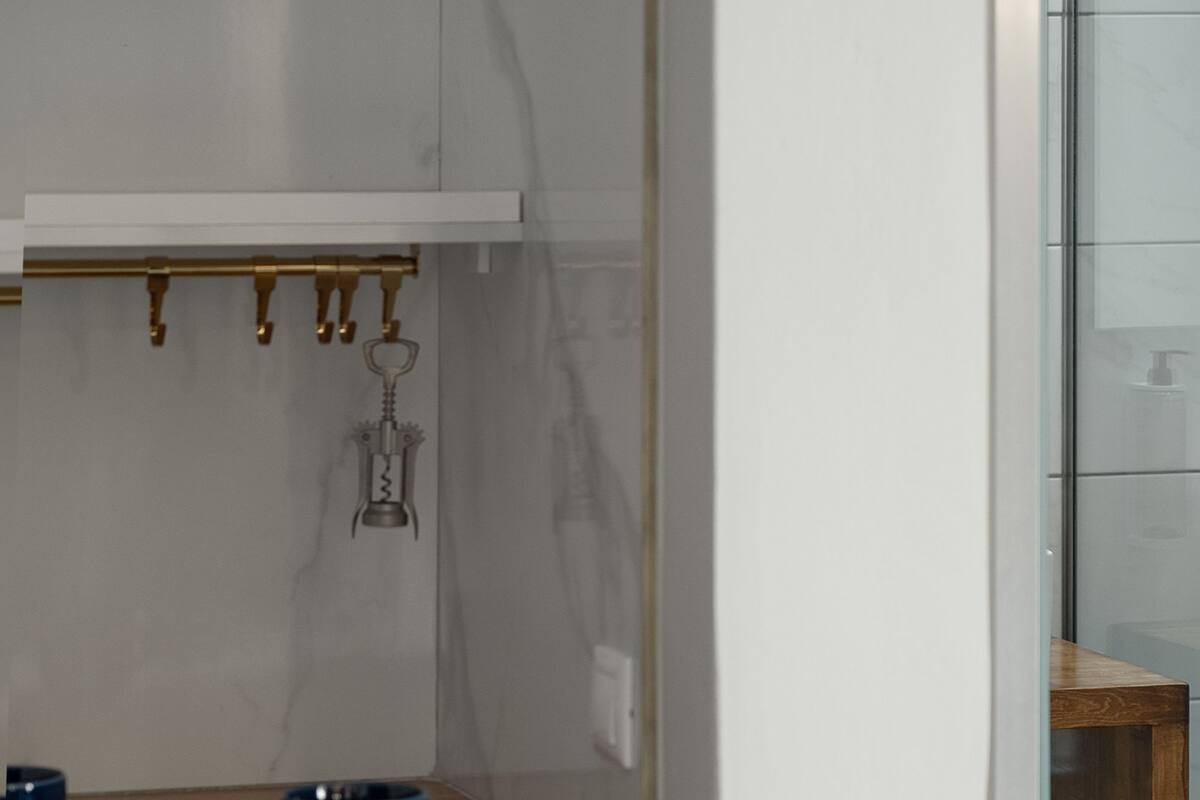 A kitchen with a wooden countertop, a blue bowl, and a hanging keychain.