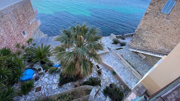A stone building with a view of the sea.
