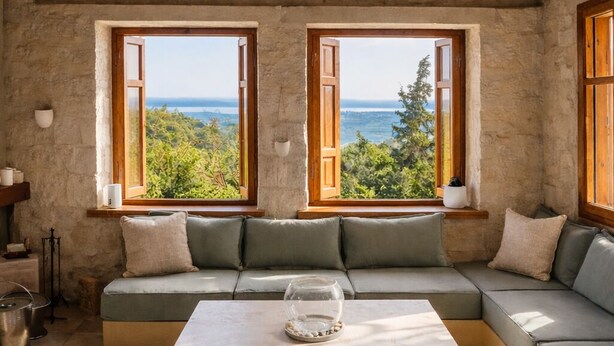A cozy room with a wooden ceiling, a large window with a view, a sofa, and a coffee table. - Pervola Private Stone Estate | 5 acres Exclusive Grove and Pool (gazion)