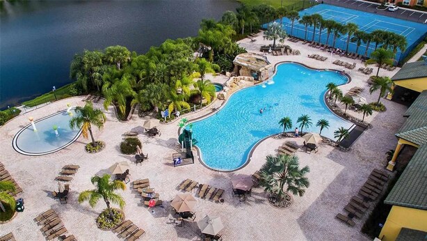 A resort with a large central pool, multiple smaller pools, and a tennis court. - Themed 5Bd Paradise Palms Close to Disney w Pool 8951 (Kissimmee)