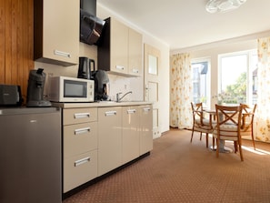 A modern kitchen with a built-in microwave, coffee maker, and a refrigerator. - Holiday Studio Near the Beach, Rewal (Rewal)