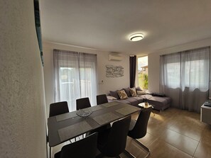 Relax in this inviting living space with a sofa set, dining table, and side table.