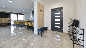 Un intérieur moderne comprenant un coin repas, un banc et une porte au design original.
