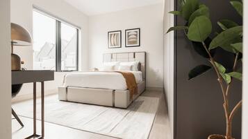 A modern bedroom with a bed, bedside table, and a large window.