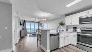 A modern kitchen with a dishwasher, stove, and microwave.