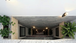 A spacious interior with a high ceiling, recessed lighting, and a marble floor. - Ho Quy Ly Holiday Apartment for Family (Ho Chi Minh City)