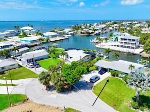 A marina with boats, a large body of water, and several buildings with balconies.