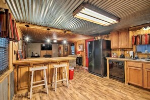 Enjoy cooking in this well-equipped kitchen with a central island, stove, and refrigerator.