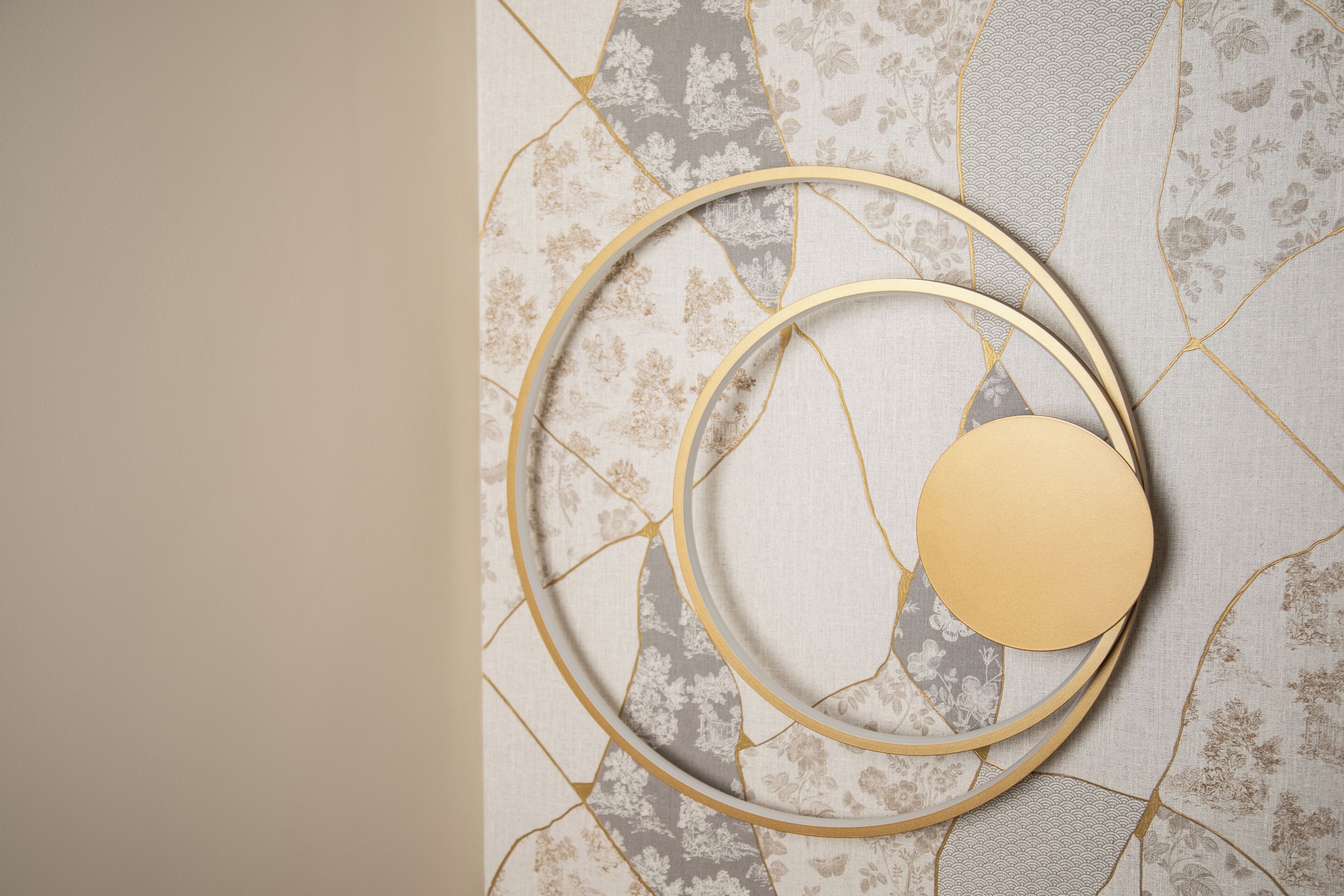 A patterned wall with a circular design and a plain section.