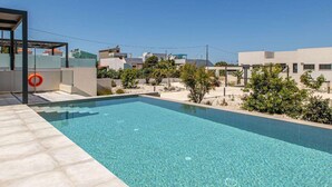 A rectangular swimming pool with clear blue water, surrounded by a tiled deck. - Menta Villa - Two Bedroom Villa, Sleeps 4 (Tavronitis)