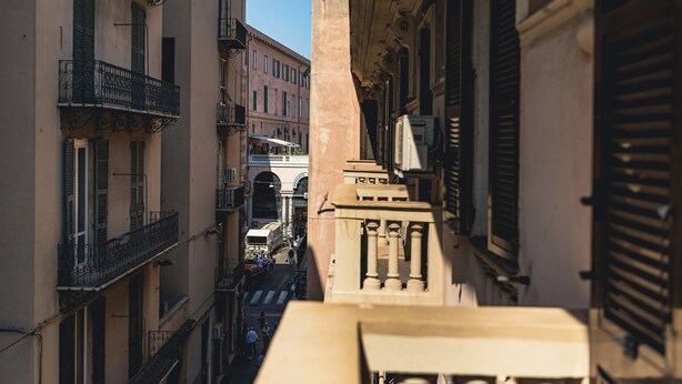 A narrow street between buildings with balconies and a central archway. - Palmaria suite, charming 1 bedroom apartment in delightful Genova with AC, WIFII (Genova)
