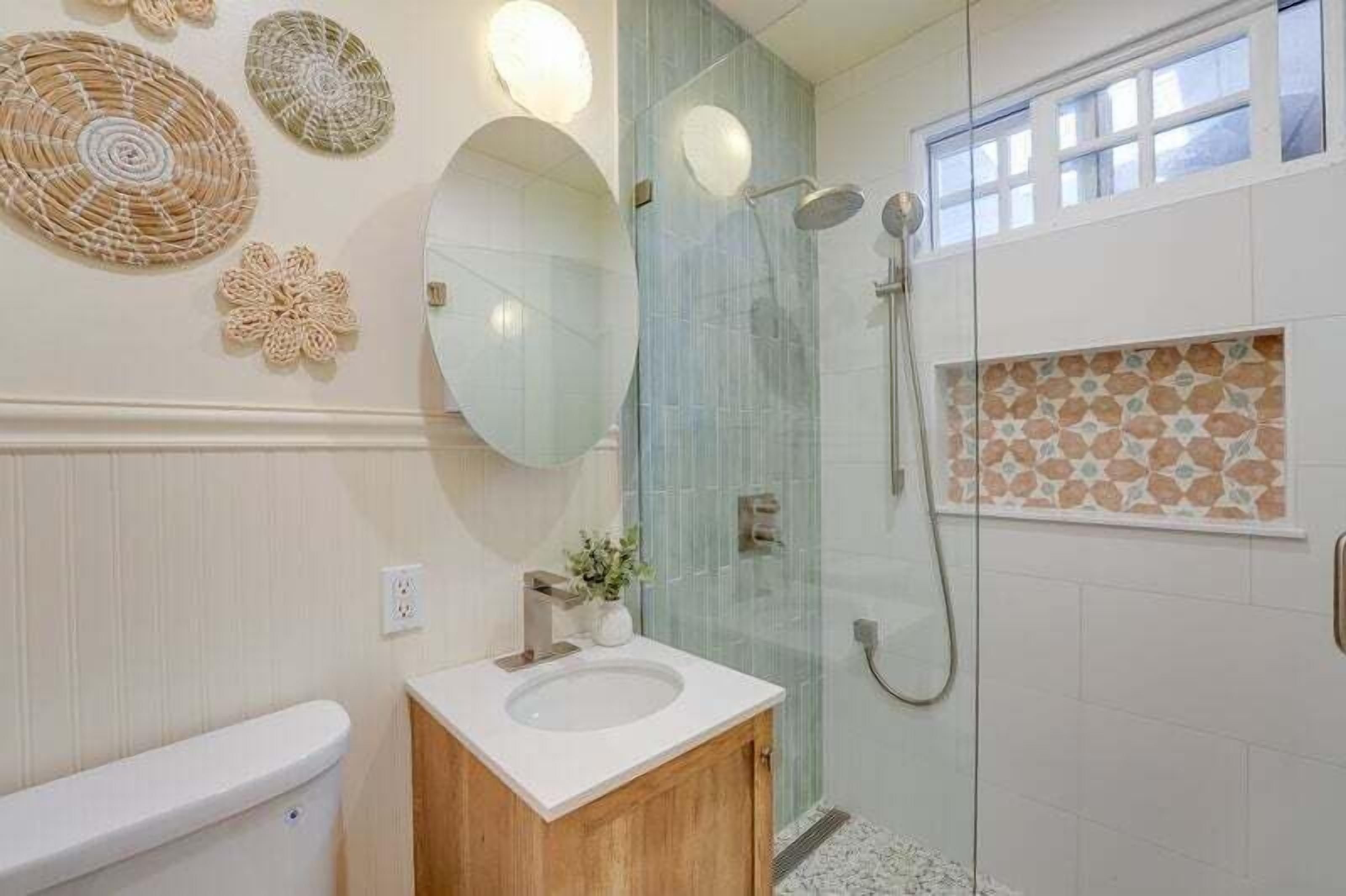 A bathroom with a toilet, sink, and shower.