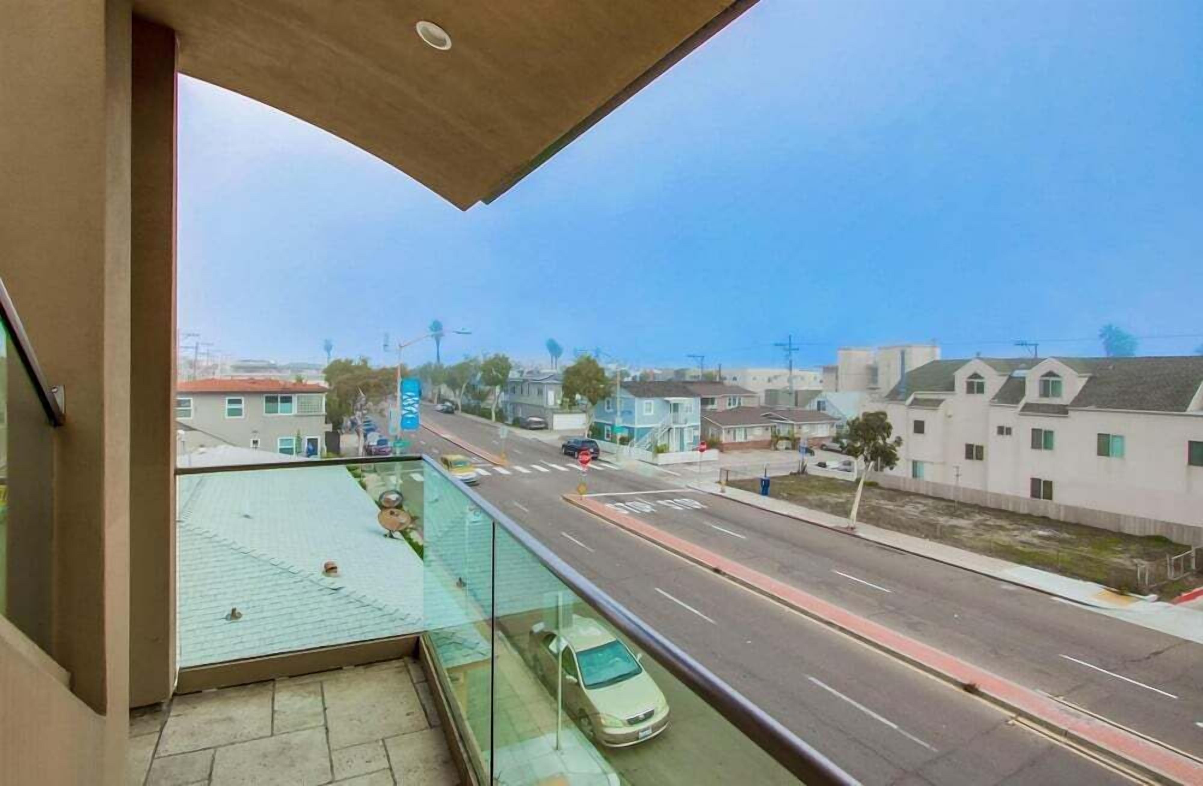 A balcony with a view of a residential street.