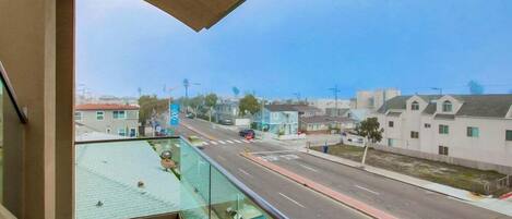 A balcony with a view of a residential street.