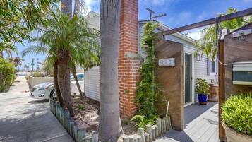 Enjoy the serene garden and outdoor space, complete with a brick chimney and wooden deck.