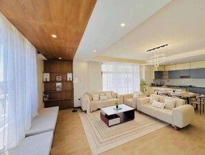 Relax in this stylish living room with a sofa set, coffee table, and area rug.
