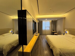 A hotel room with two beds, a TV, a desk, and a small table. - Guilin Tree Hotel (Guilin)