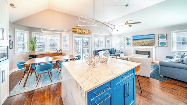 A spacious living area with a large island, a fireplace, and a view of the beach. - Ocean City Beach Block: 5BR/4BA with Full Linen Service- Perfect for Family! (Ocean City)