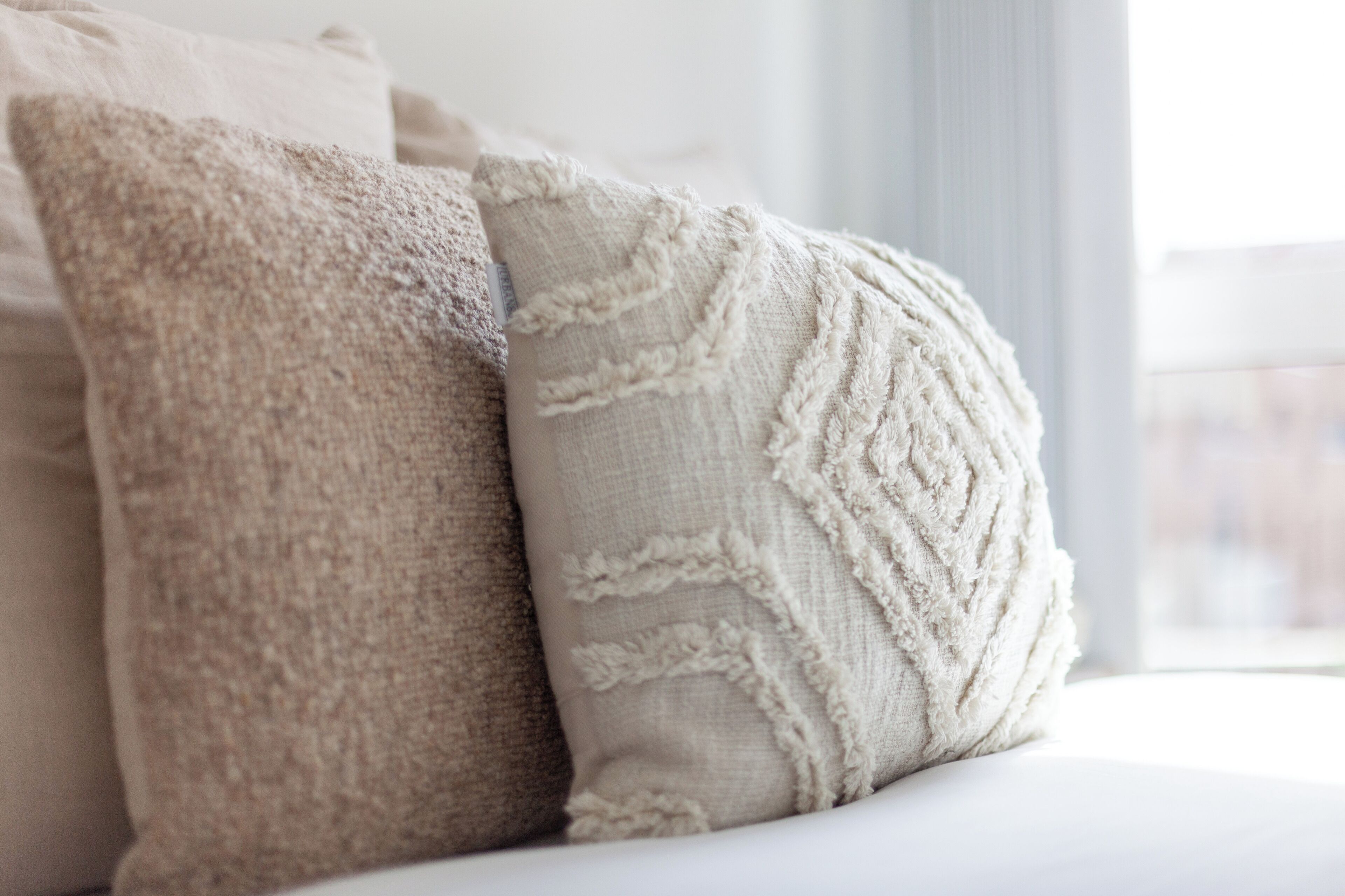 Two pillows on a bed.
