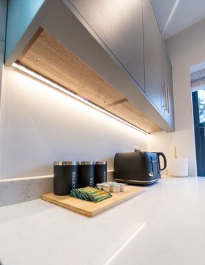 Enjoy a convenient coffee and tea station with coffee machine and kettle.