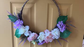 A door with a wreath made of branches and flowers.