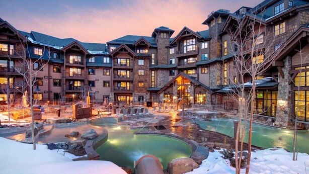 A lodge with multiple buildings, a central pool, and outdoor seating areas. - Exquisite ski-in, ski-out! 1 or 2-bedroom condo on Peak 7 in Breckenridge! (Breckenridge)