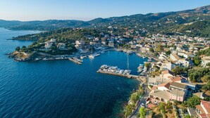 An aerial view of a coastal town with a marina, houses, and hilly terrain. - Bayside House in Corfu (Corfu)